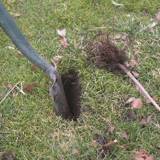 Spade inserted into a slit in the ground